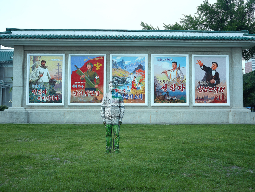 'Posters' (The shooting of this camouflage bodpainting took place in front of the poster booth of a movie theater on the street in Pyongyang/North Korea).