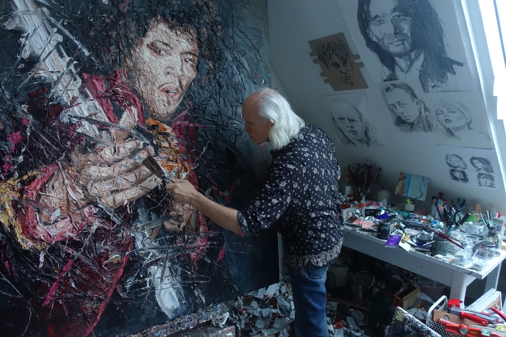 Oliver Jordan in his roof studio putting finishing touches with a spatula on Jimi Hendrix.